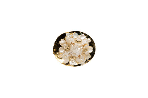 Broche ovalado con base dorada martillada, decorado con un ramo de pequeñas flores